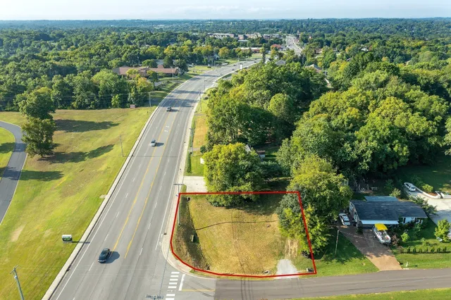 an aerial view of residential houses with outdoor space and swimming pool