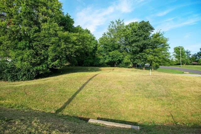 a view of a large pool with an outdoor space and seating area