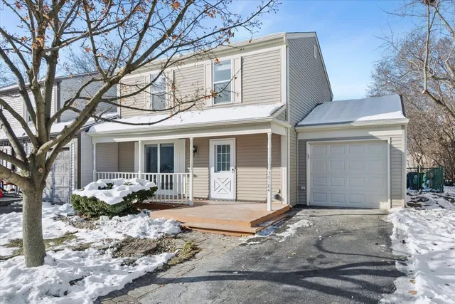 a front view of a house with a yard and glass windows