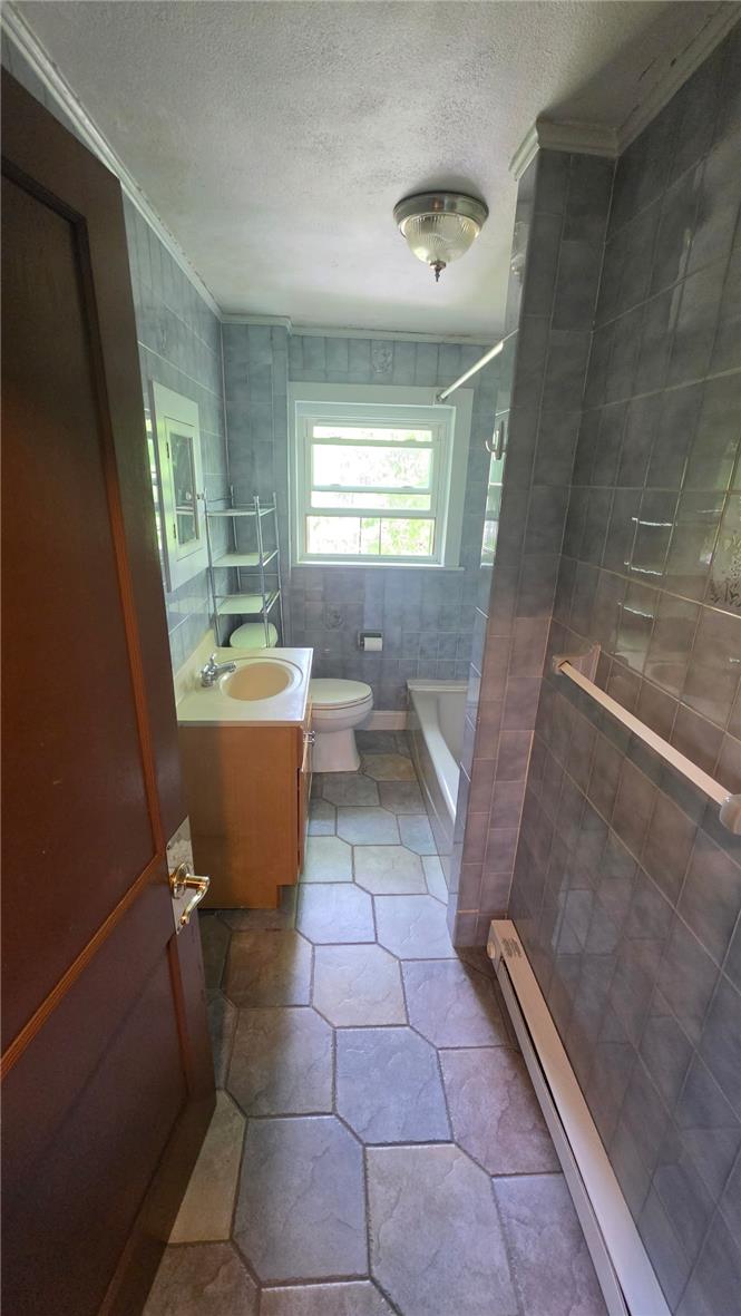 233 East Ridge Street Lansford, PA 18232 - Photo 3 of 10 A well-maintained full bathroom offers a tub/shower combination, vanity, and ample natural light.