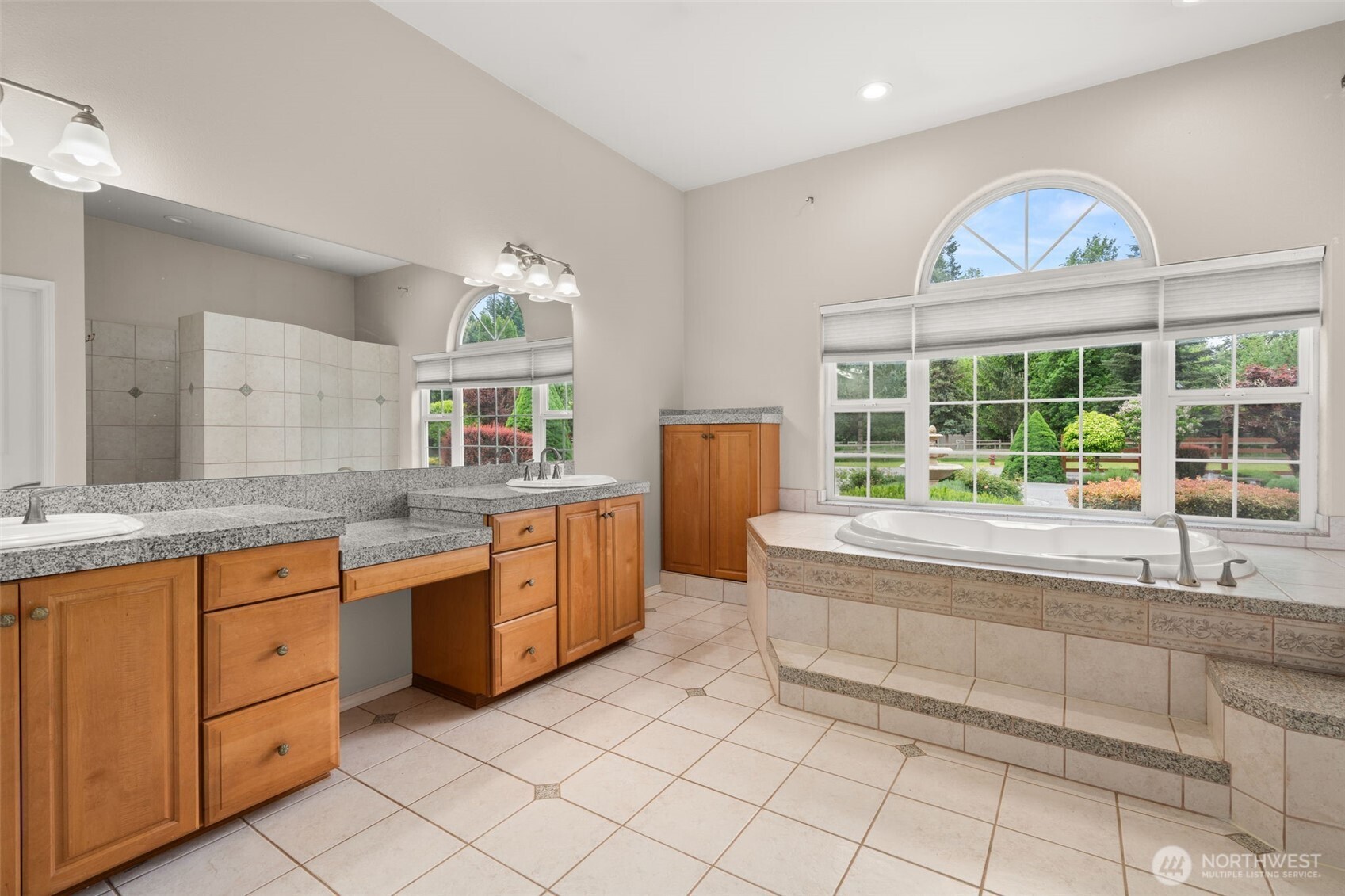 9609 346th Street South Roy, WA 98580 - Photo 15 of 37 a spacious bathroom with a granite countertop sink and a large mirror