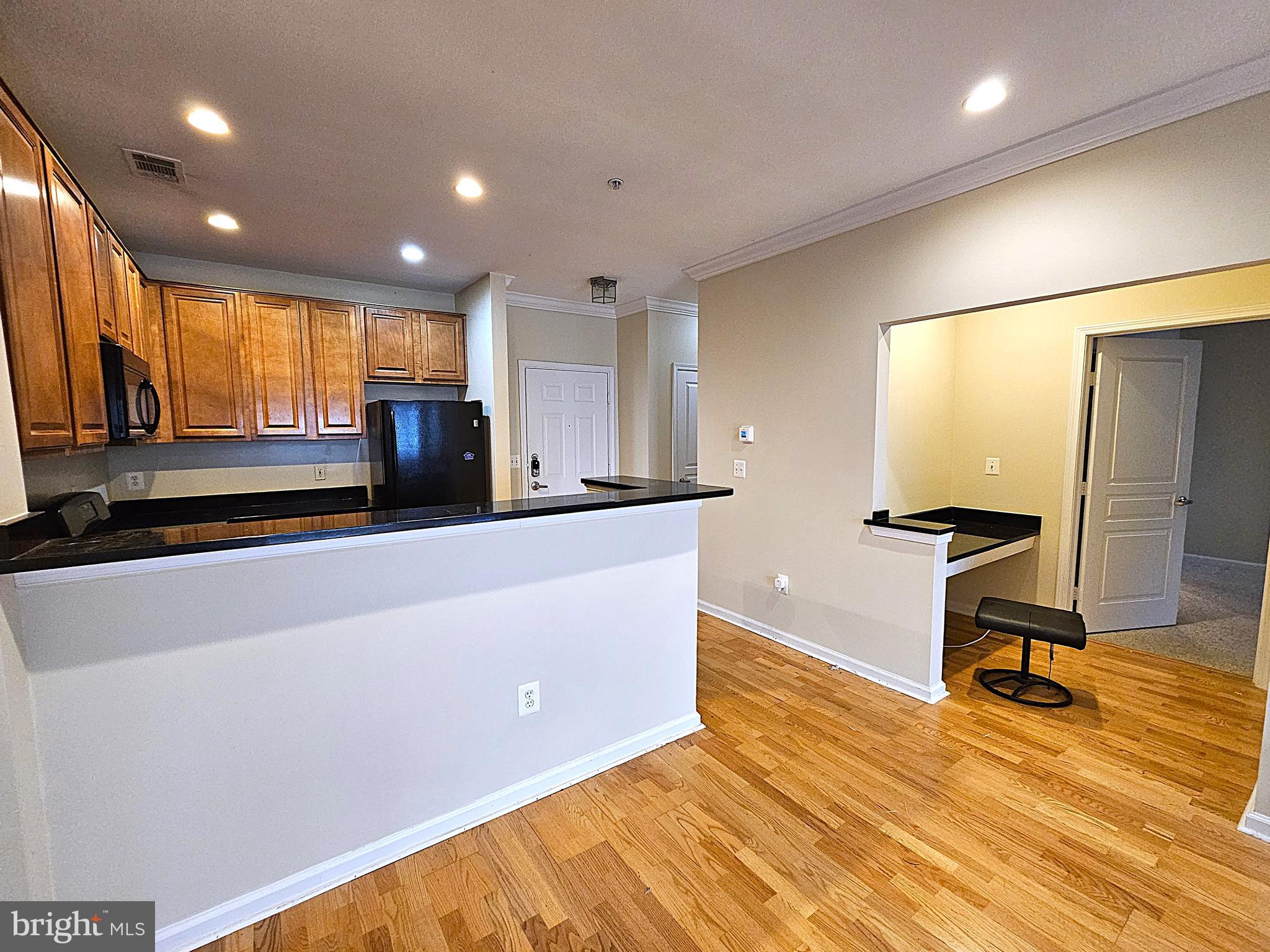 12000 Market Street, Unit 283 Reston, VA 20190 - Photo 17 of 36 a living room with furniture and a flat screen tv