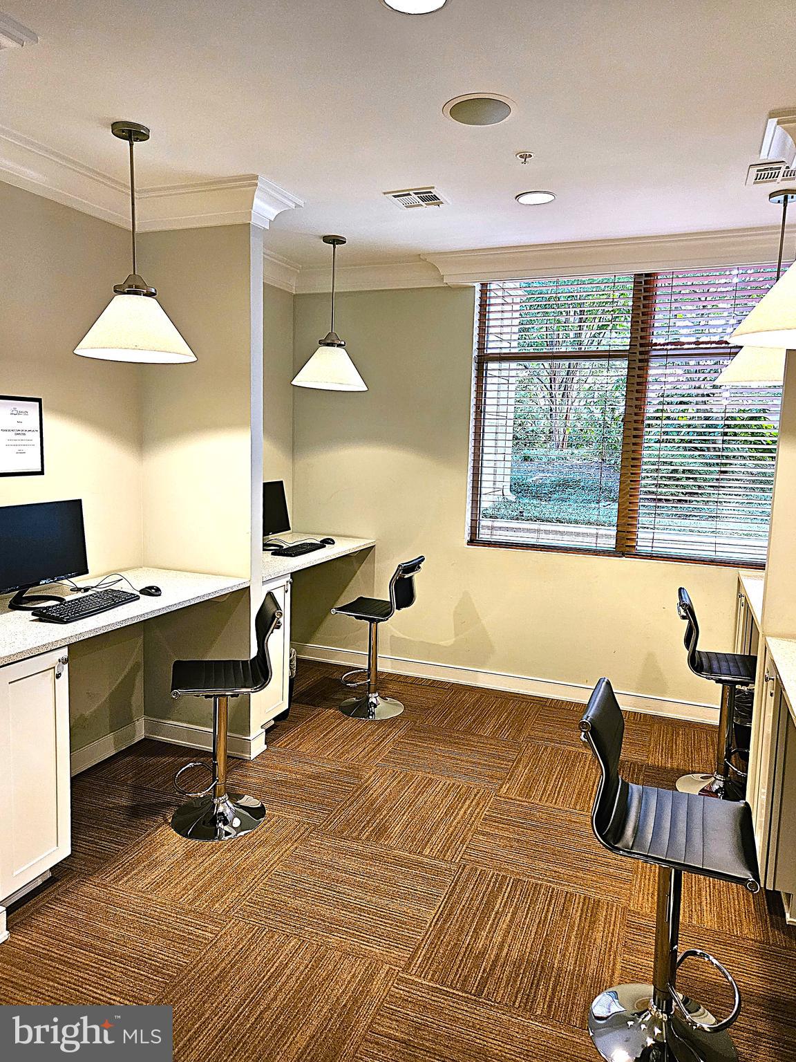 12000 Market Street, Unit 283 Reston, VA 20190 - Photo 31 of 36 a workspace with furniture a rug and a large window