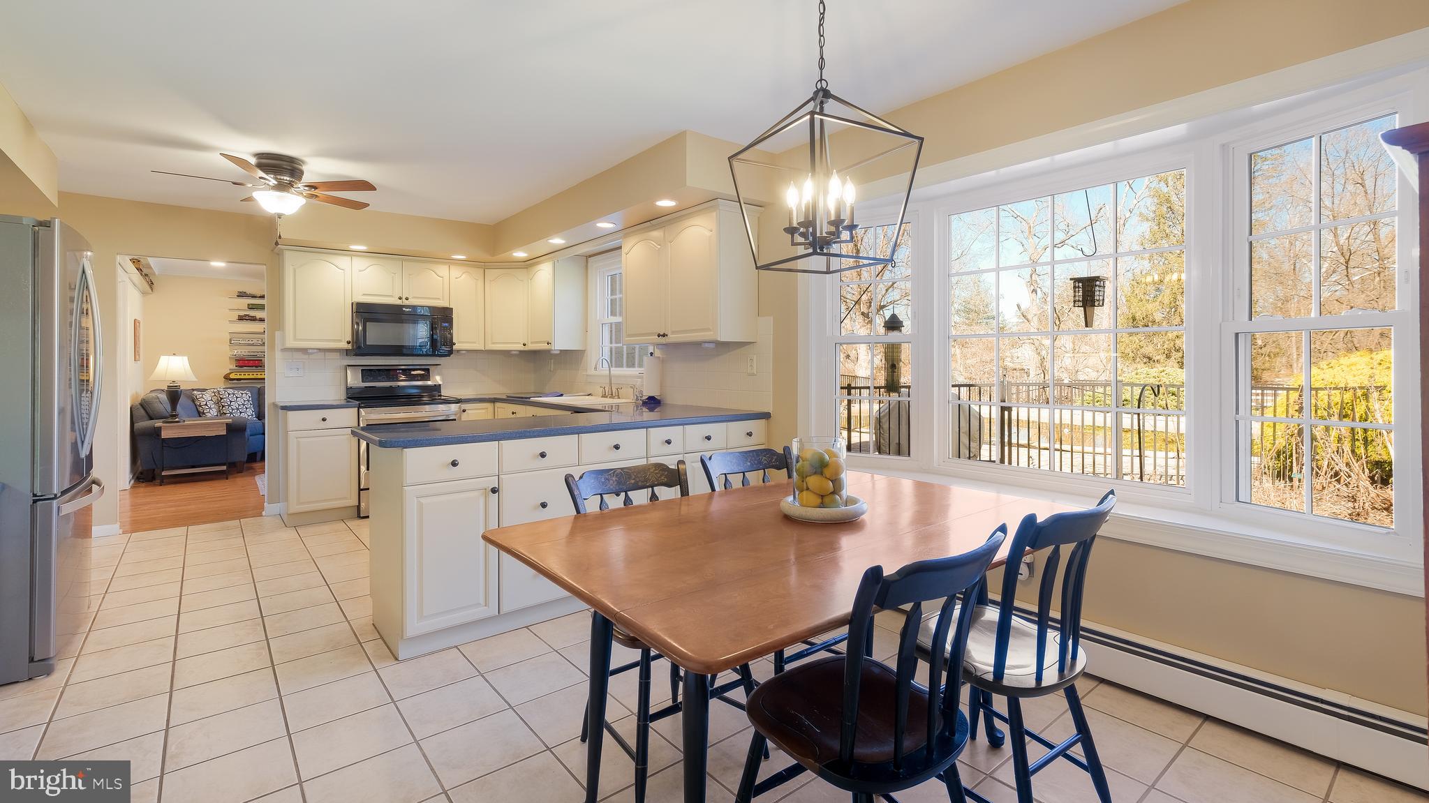 12 Pine Valley Road Doylestown, PA 18901 - Photo 13 of 63 a view of a dining room and livingroom with furniture wooden floor a chandelier