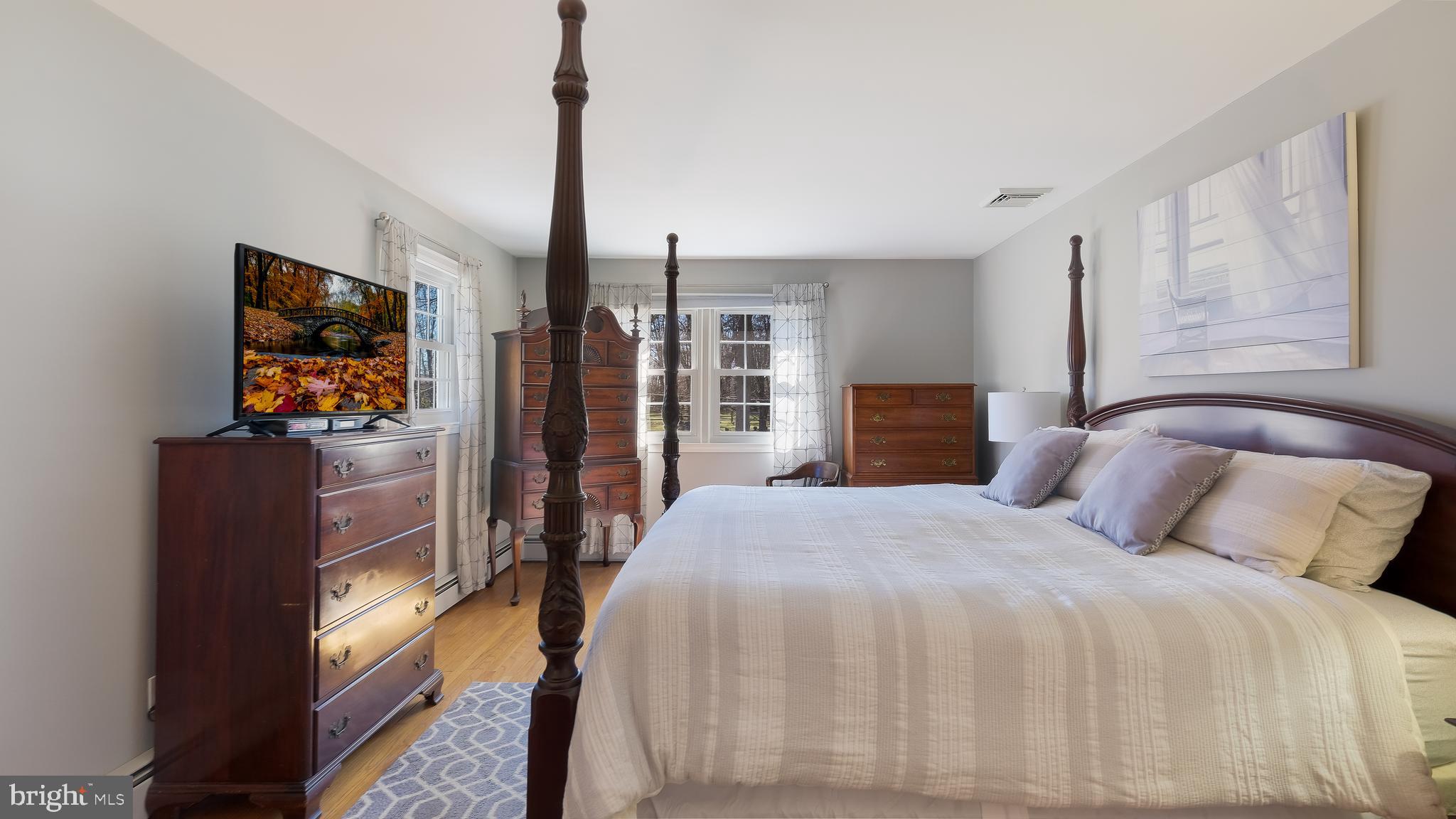 12 Pine Valley Road Doylestown, PA 18901 - Photo 26 of 63 a bedroom with a large bed and a flat tv screen on dresser