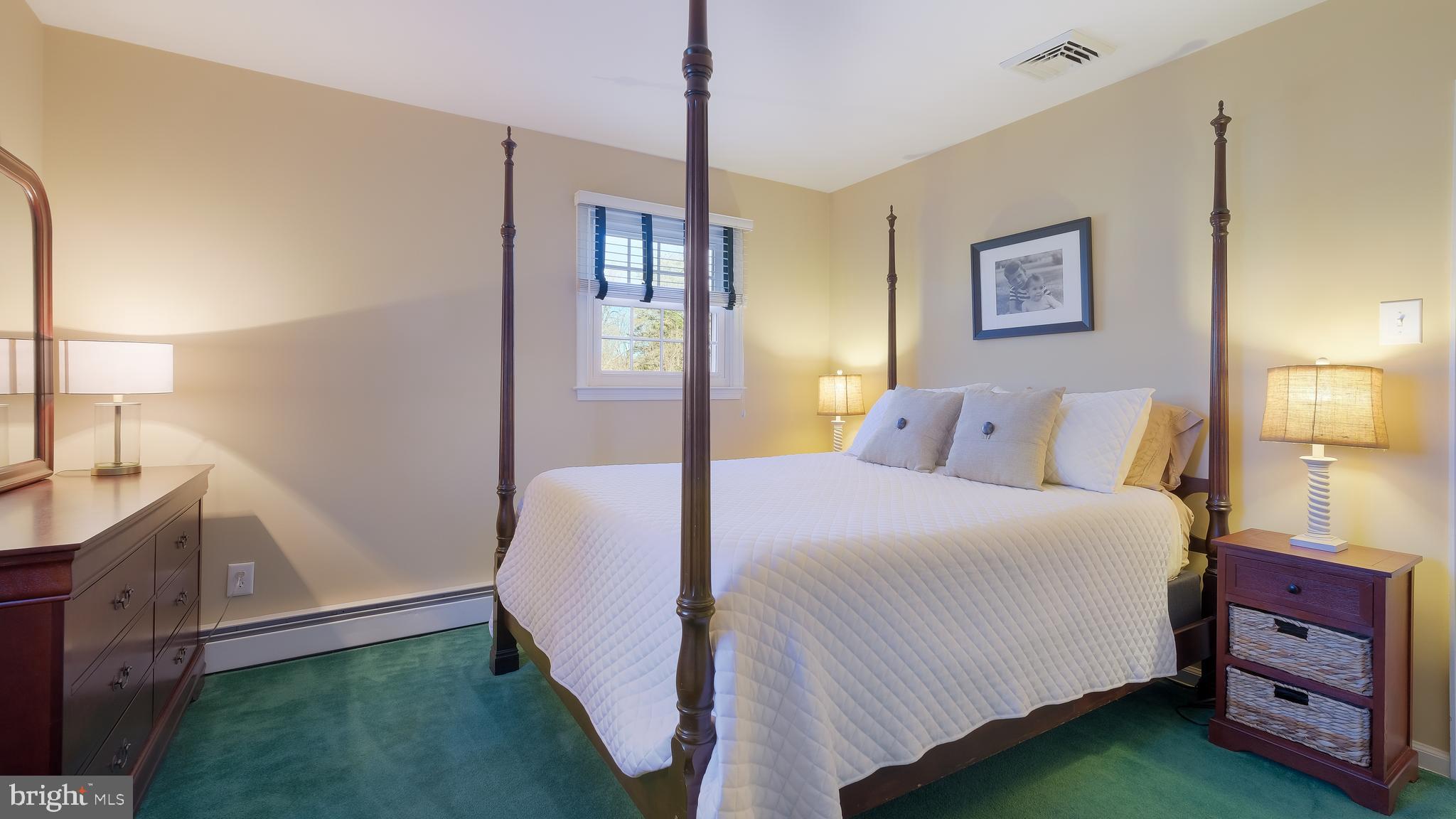 12 Pine Valley Road Doylestown, PA 18901 - Photo 37 of 63 a bedroom with a bed and a dresser with mirror