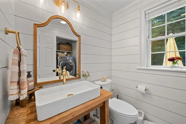 a bathroom with a sink a toilet and a mirror