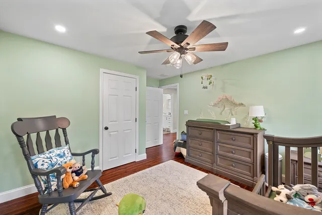 a bedroom with furniture and wooden floor
