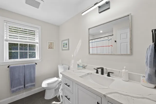 a bathroom with a sink toilet and mirror