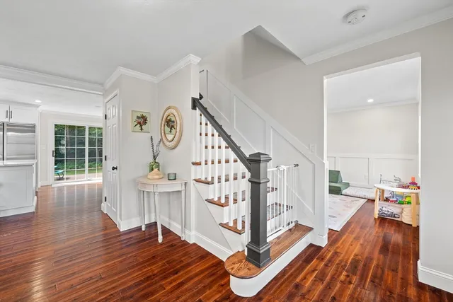 a view of entryway with wooden floor and front door