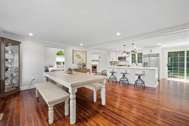 a large kitchen with a table and chairs