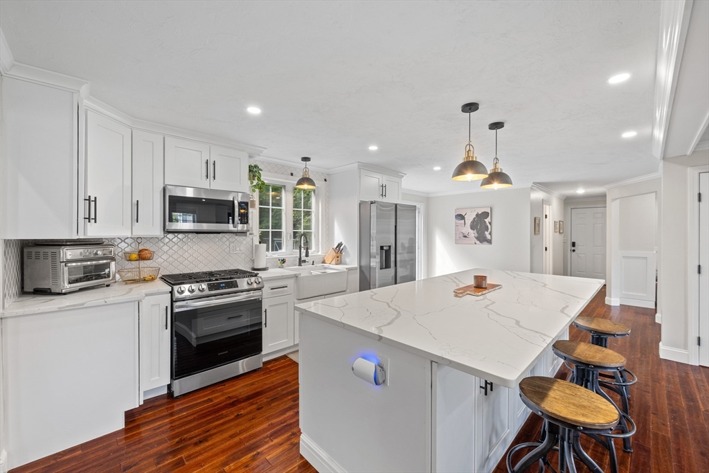 8 Virginia Avenue Sutton, MA 01590 - Photo 7 of 42 a large kitchen with kitchen island a stove a sink a stove and a refrigerator