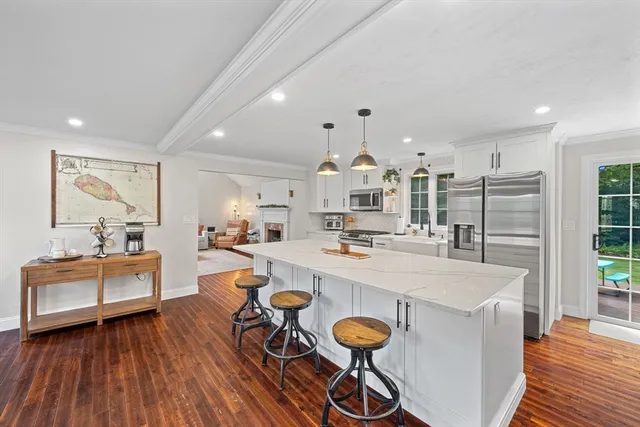 a large kitchen with a table and chairs