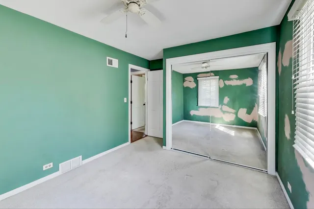 a view of a hallway with a livingroom and entryway