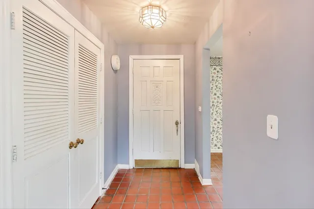 a view of a livingroom with wooden floor and a large window