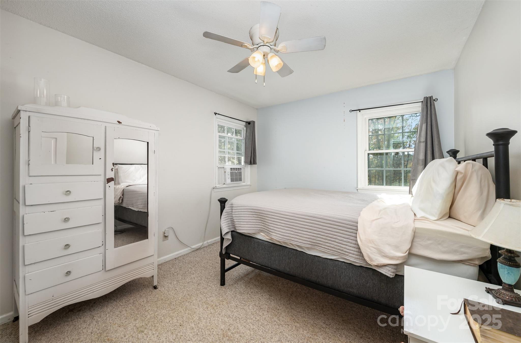 302 Nottingham Way Wadesboro, NC 28170 - Photo 11 of 30 a bedroom with a bed and a chandelier