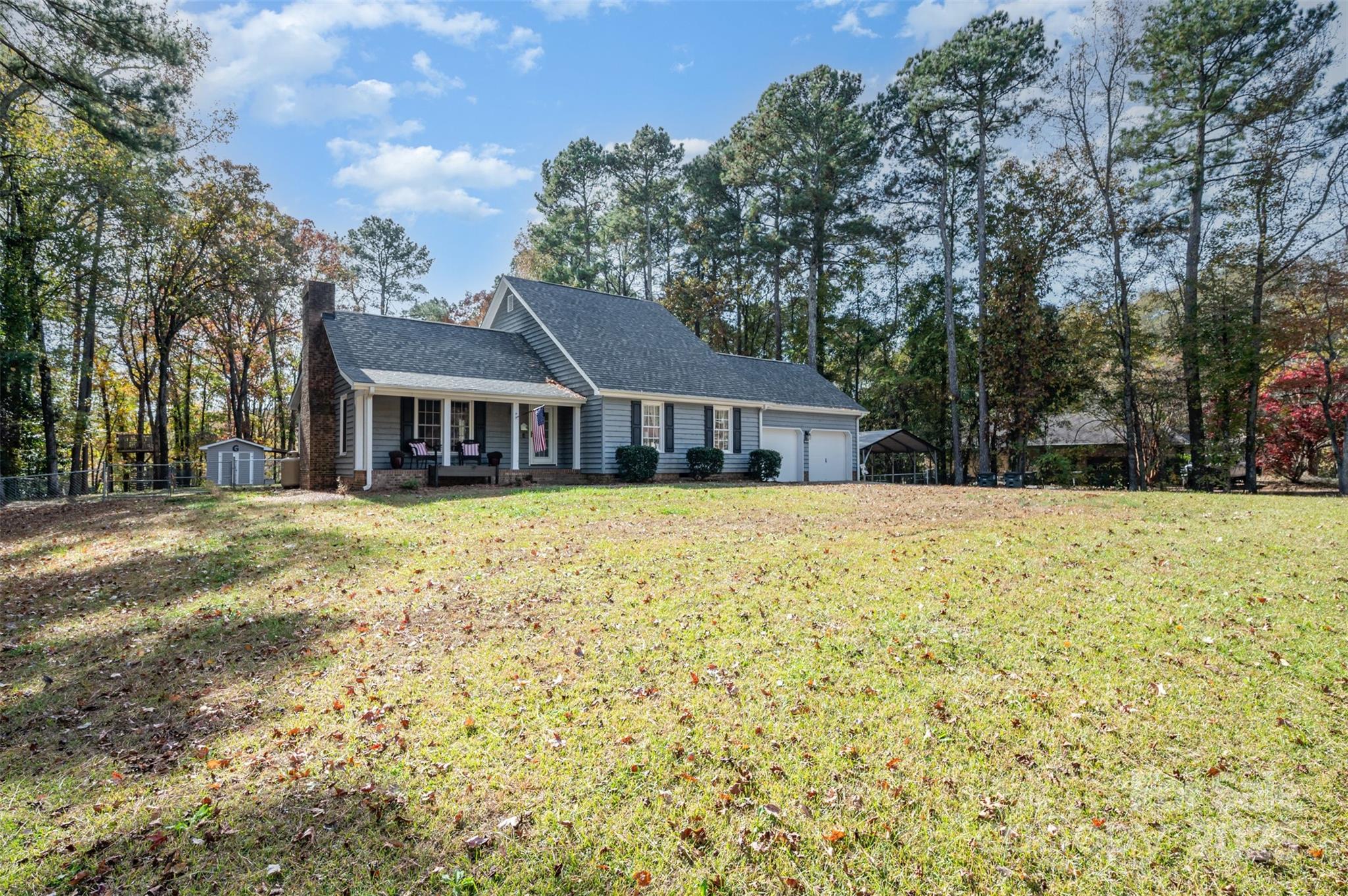 302 Nottingham Way Wadesboro, NC 28170 - Photo 15 of 30 a white house with a large tree with yard