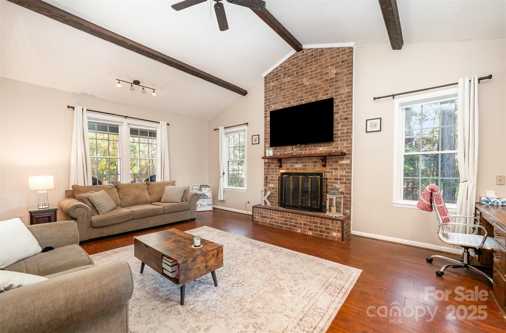 302 Nottingham Way Wadesboro, NC 28170 - Photo 19 of 30 a living room with furniture a flat screen tv and a fireplace