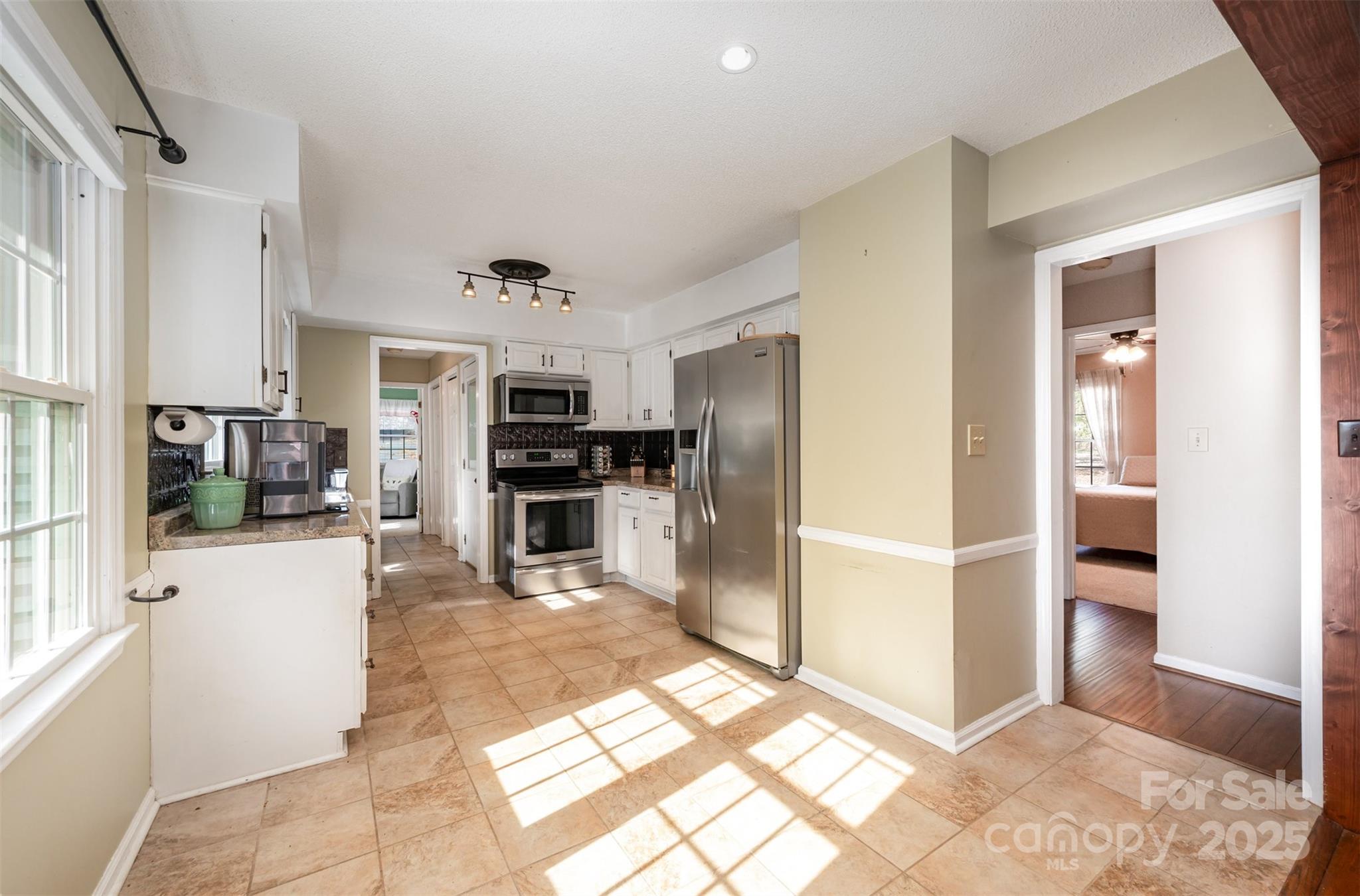 302 Nottingham Way Wadesboro, NC 28170 - Photo 23 of 30 a kitchen with stainless steel appliances kitchen island granite countertop a refrigerator and a sink