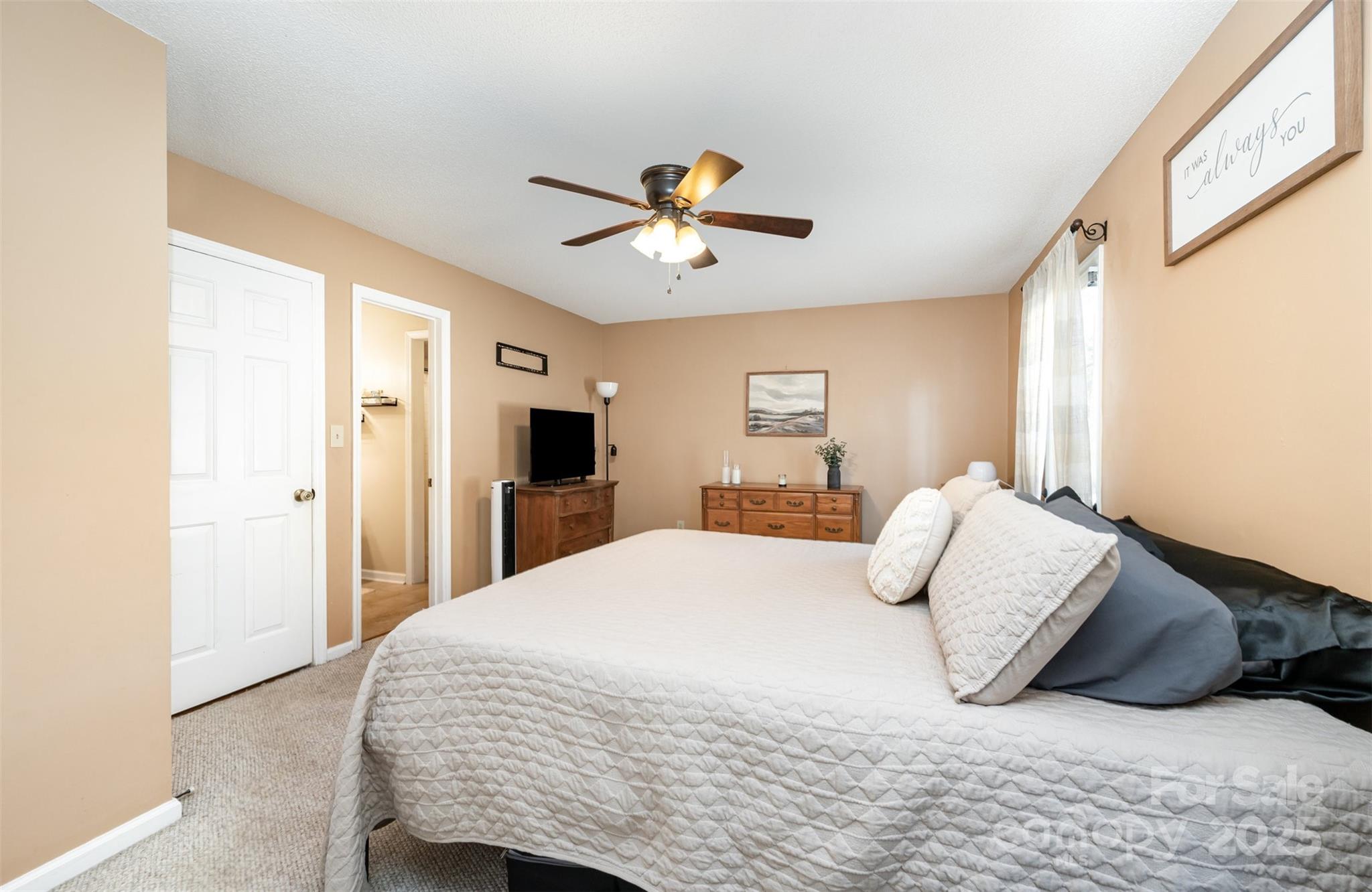 302 Nottingham Way Wadesboro, NC 28170 - Photo 25 of 30 a bedroom with a bed and a chandelier