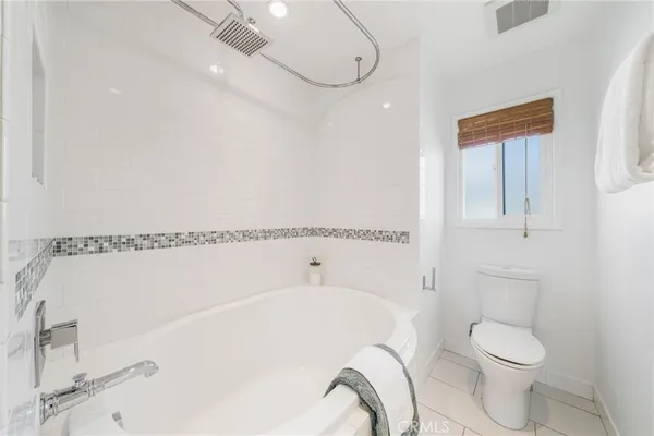 a bathroom with a bathtub and a toilet