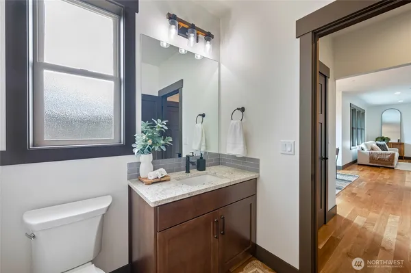 a view of bathroom with a toilet sink and mirror