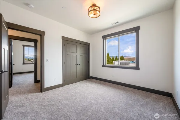 an empty room that has a window and painted walls