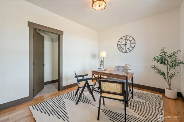 a view of a room with a table and chairs