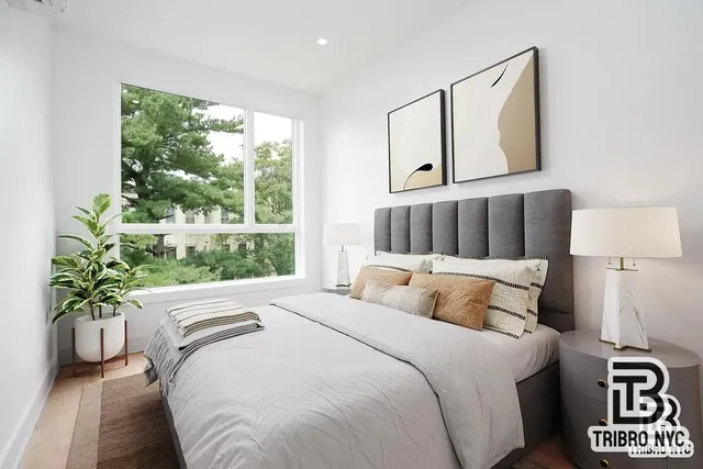 a bedroom with a bed and a potted plant