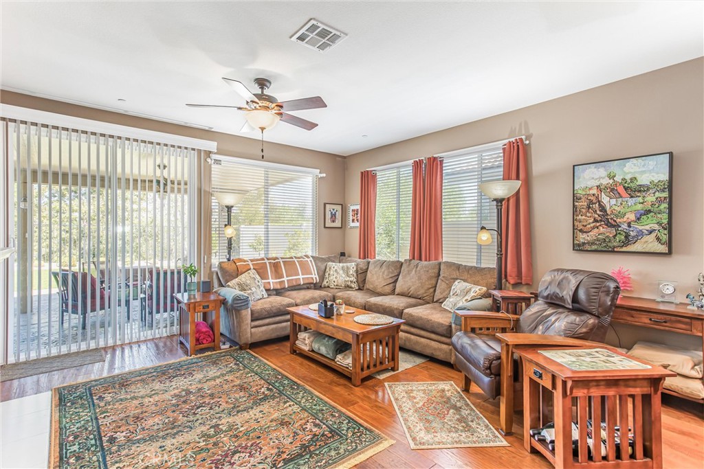 1476 Signal Peak Beaumont, CA 92223 - Photo 13 of 50 a living room with furniture two large windows with wooden floor