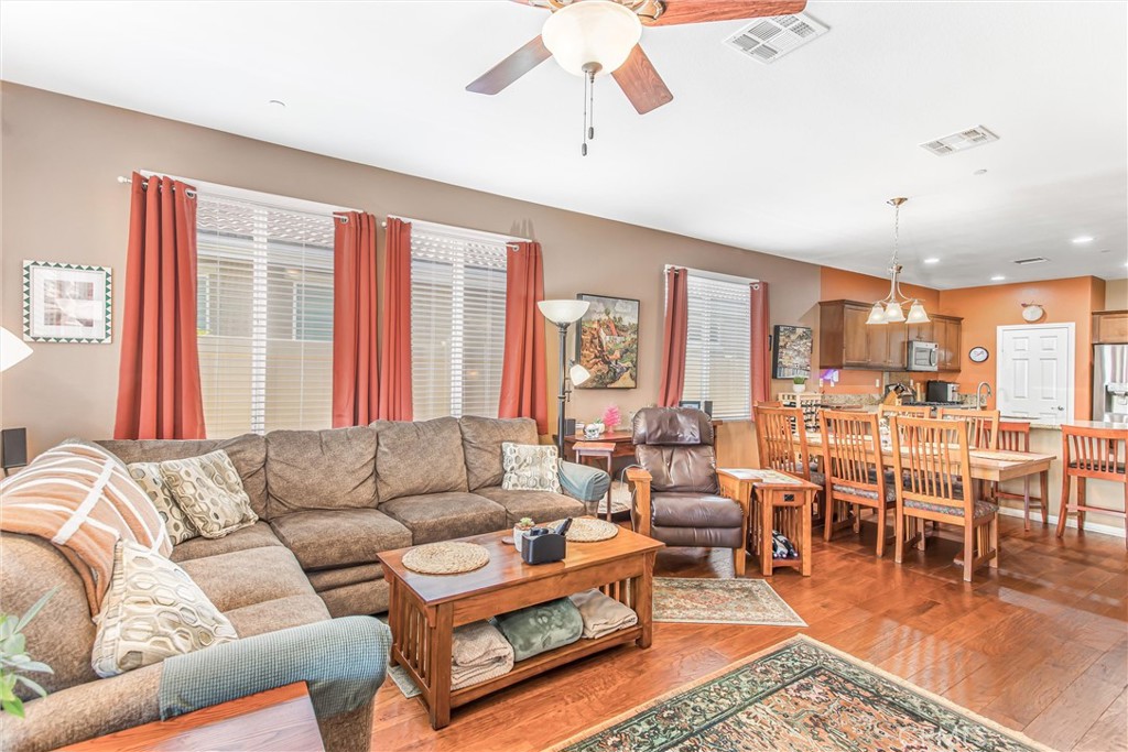 1476 Signal Peak Beaumont, CA 92223 - Photo 14 of 50 a living room with furniture wooden floor and a large window