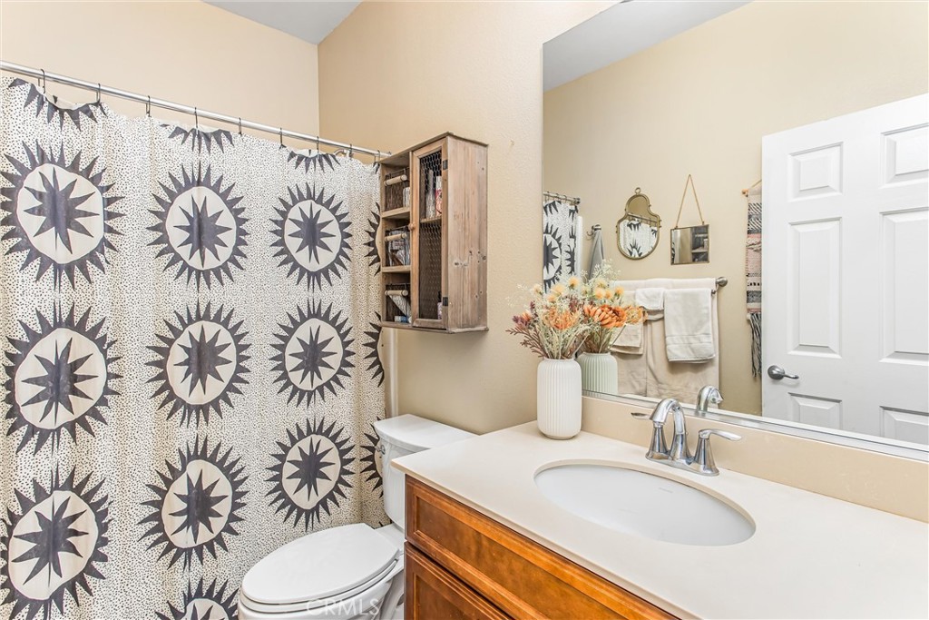 1476 Signal Peak Beaumont, CA 92223 - Photo 17 of 50 a bathroom with a sink toilet and shower