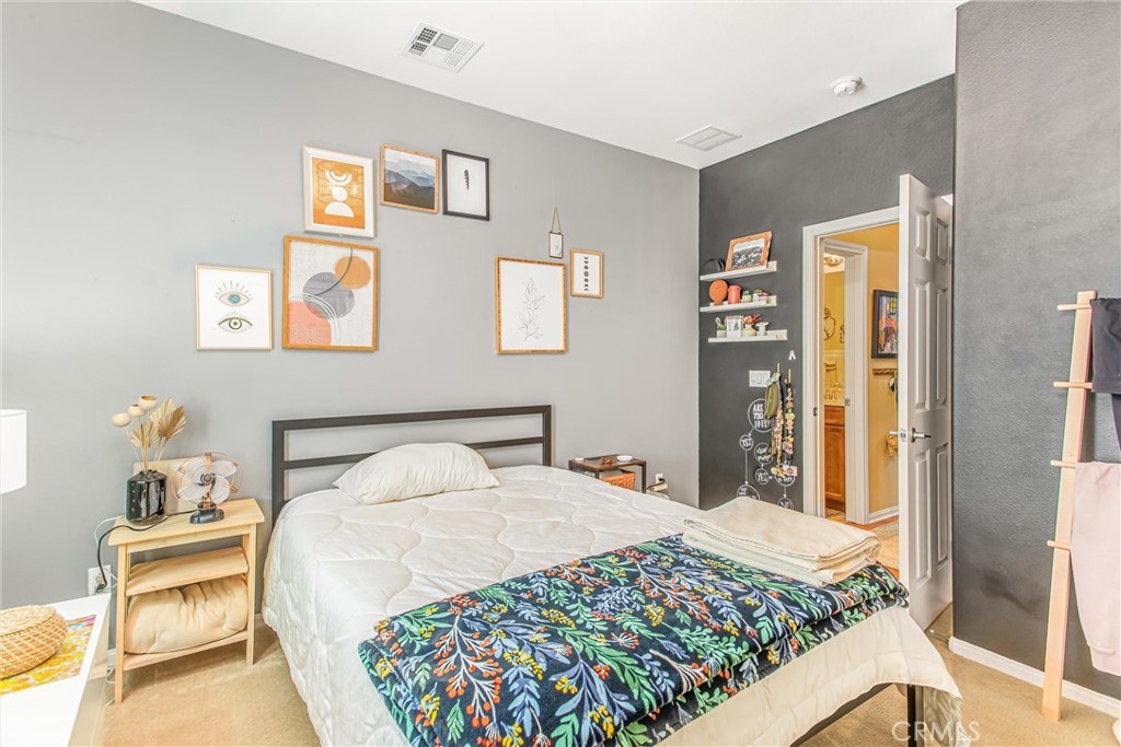 1476 Signal Peak Beaumont, CA 92223 - Photo 18 of 50 a bedroom with a bed and wooden floor