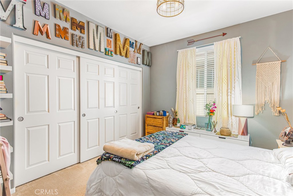 1476 Signal Peak Beaumont, CA 92223 - Photo 19 of 50 a bedroom with furniture and a book shelf
