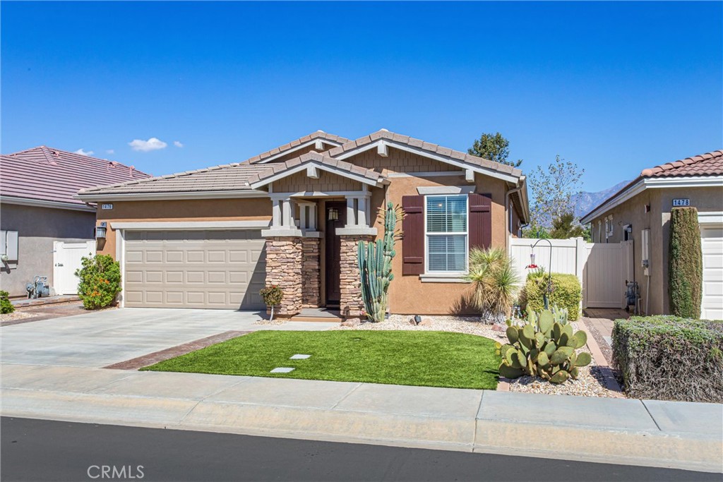 1476 Signal Peak Beaumont, CA 92223 - Photo 2 of 50 a front view of a house with a yard and garage