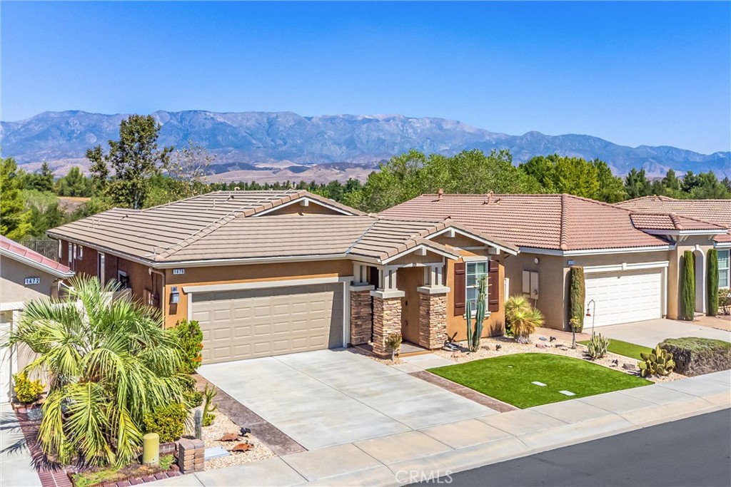 1476 Signal Peak Beaumont, CA 92223 - Photo 28 of 50 a front view of a house with a yard and mountain view