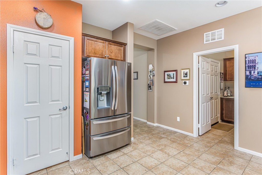 1476 Signal Peak Beaumont, CA 92223 - Photo 9 of 50 a view of a refrigerator in kitchen and an empty room