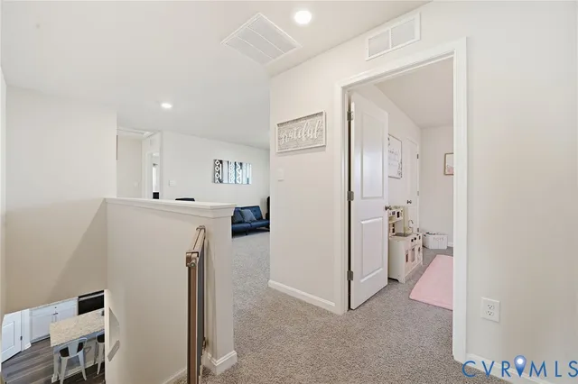 a view of a kitchen with refrigerator and wooden floor