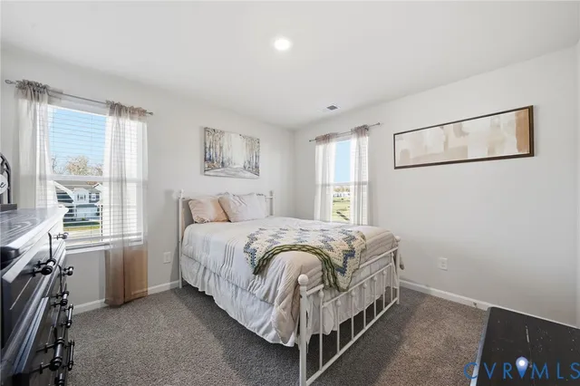 a bed sitting in a room next to a window