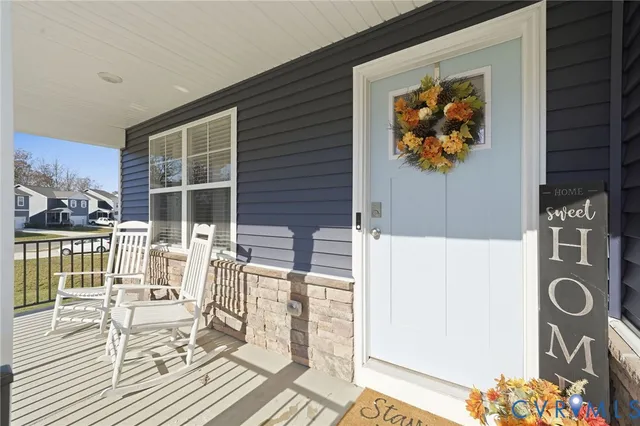 a view of balcony and living room with wooden floor