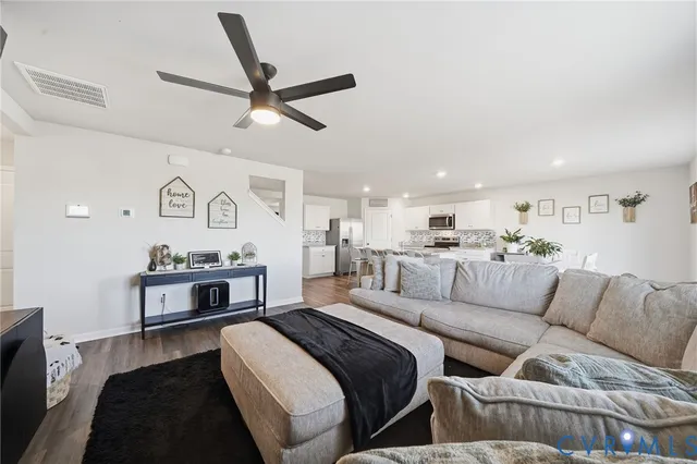 a living room with furniture and kitchen view