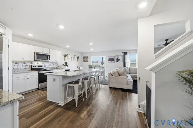 a kitchen with white cabinets and appliances