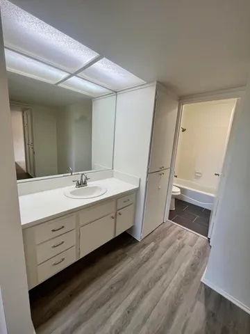 a bathroom with a double vanity sink and mirror