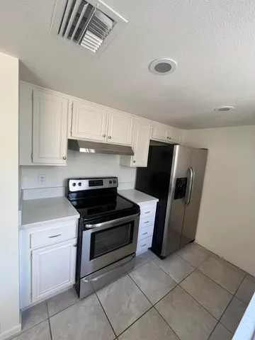 a kitchen with a stove and a refrigerator