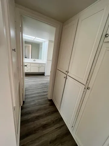 a view of a hallway with wooden floor and staircase