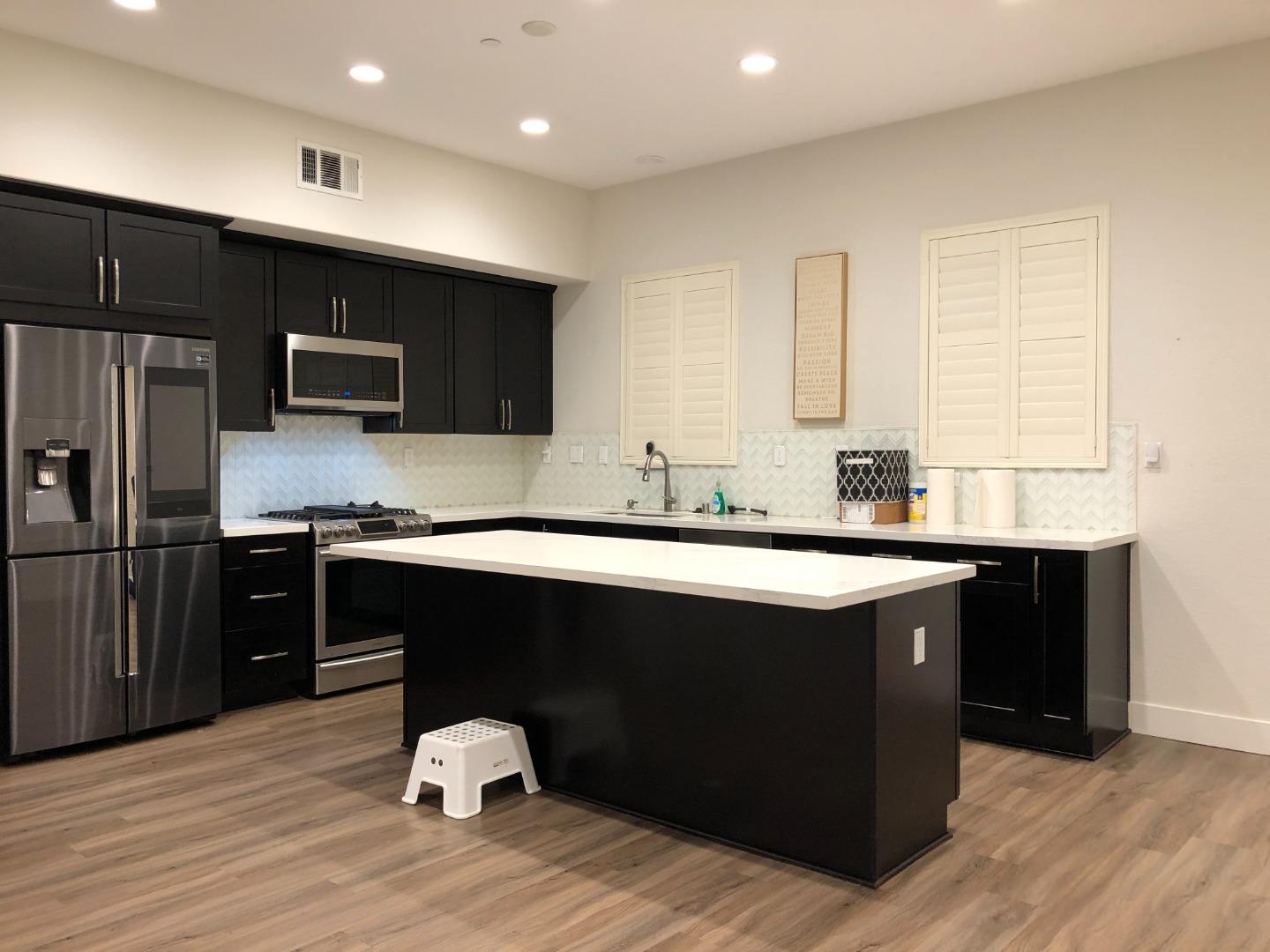 215 Houret Drive Milpitas, CA 95035 - Photo 1 of 14 a kitchen with a sink cabinets and stainless steel appliances
