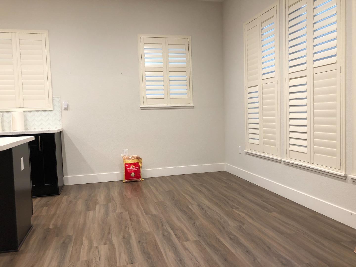 215 Houret Drive Milpitas, CA 95035 - Photo 3 of 14 an empty room with wooden floor and windows