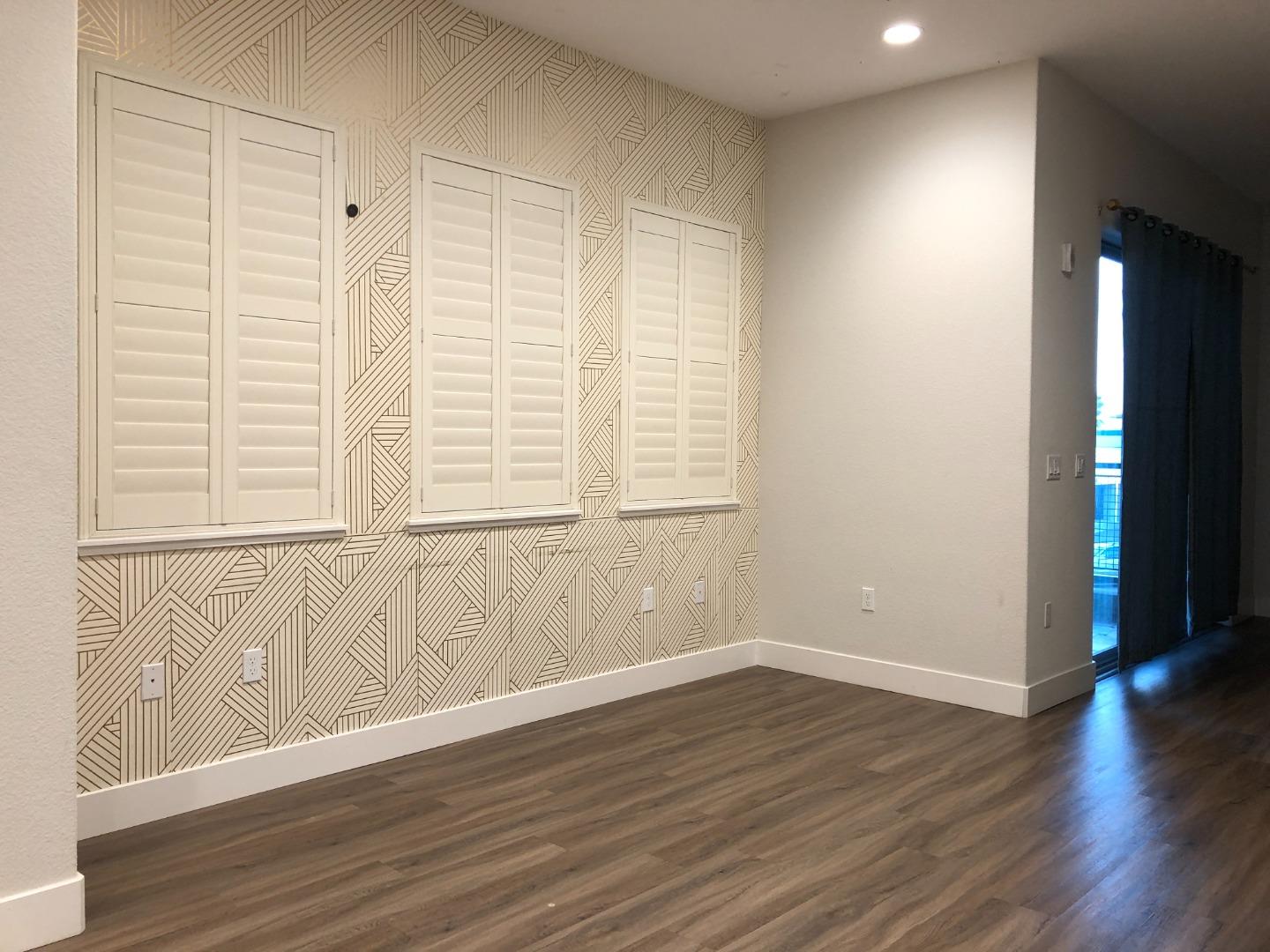 215 Houret Drive Milpitas, CA 95035 - Photo 4 of 14 a view of an empty room with wooden floor and a window