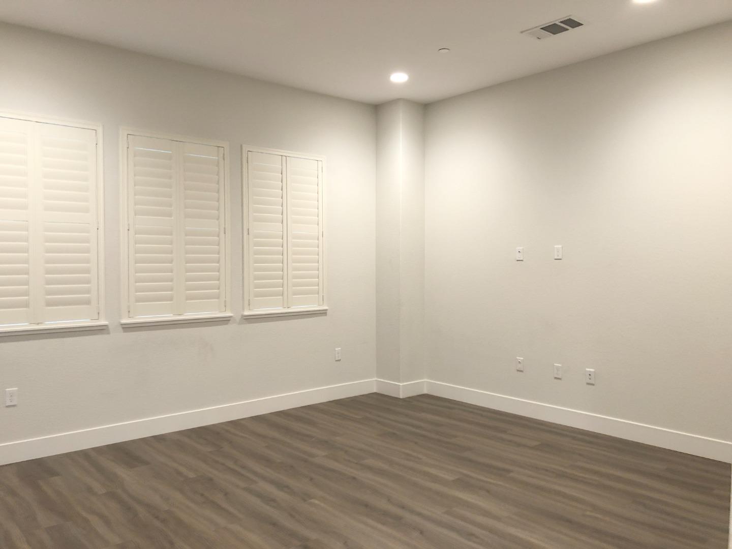 215 Houret Drive Milpitas, CA 95035 - Photo 5 of 14 wooden floor in an empty room with a window