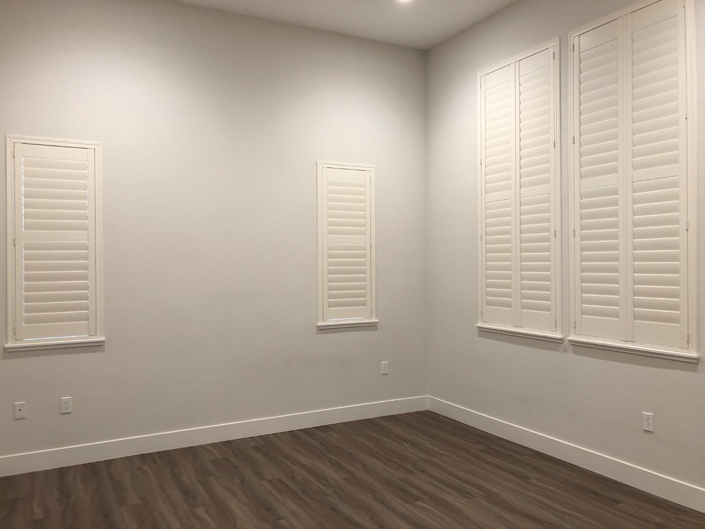 215 Houret Drive Milpitas, CA 95035 - Photo 7 of 14 a view of an empty room with wooden floor and a window
